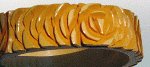 Carved into roses, what a great butterscotch bakelite bangle!